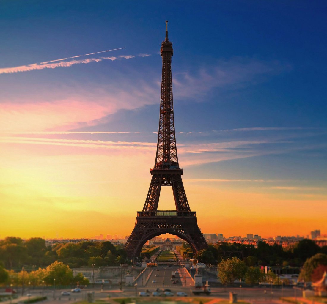 The Eiffel Tower glowing at sunset over Paris